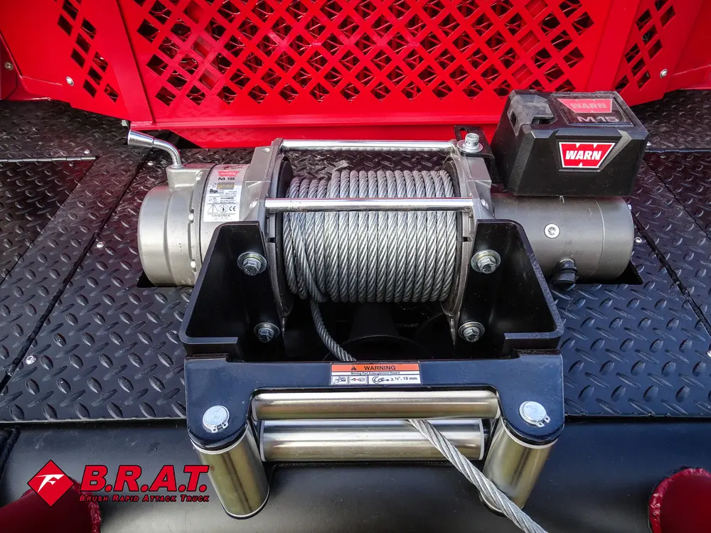 Exterior view of small fire truck showing cab, body compartments, and wheel/tire area.