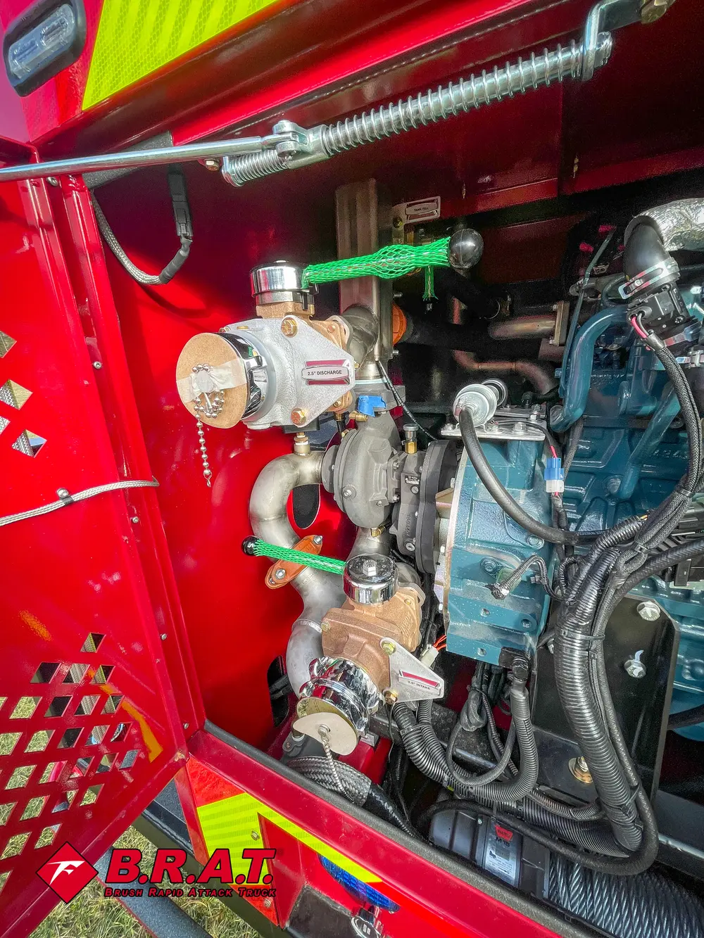 Exterior view of small fire truck showing cab, body compartments, and wheel/tire area.