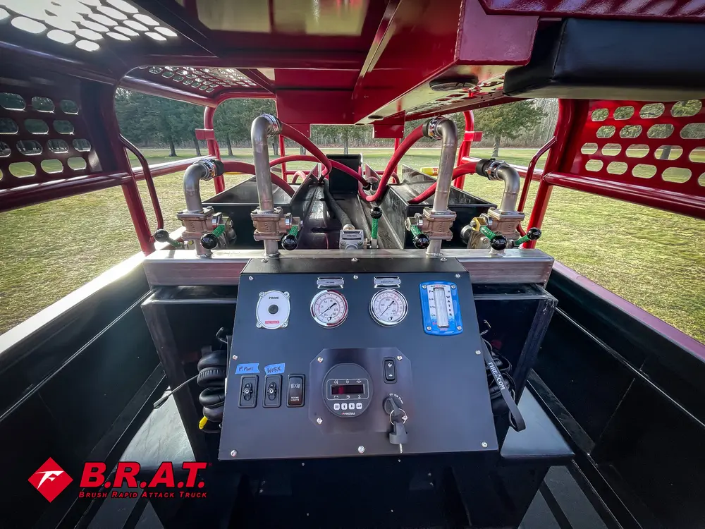 Exterior view of small fire truck showing cab, body compartments, and wheel/tire area.