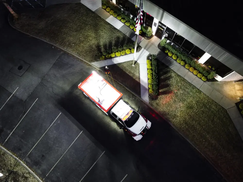 Exterior view of small fire truck showing cab, body compartments, and wheel/tire area.