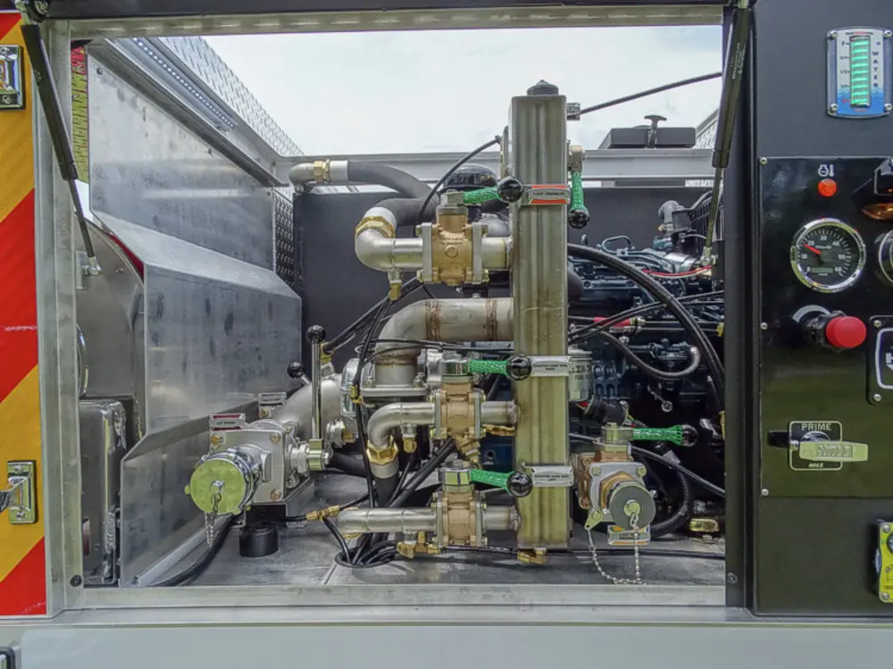 Exterior view of small fire truck showing cab, body compartments, and wheel/tire area.