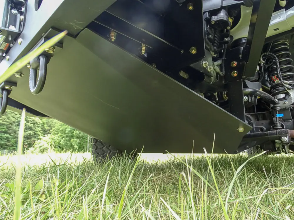 Exterior view of small fire truck showing cab, body compartments, and wheel/tire area.