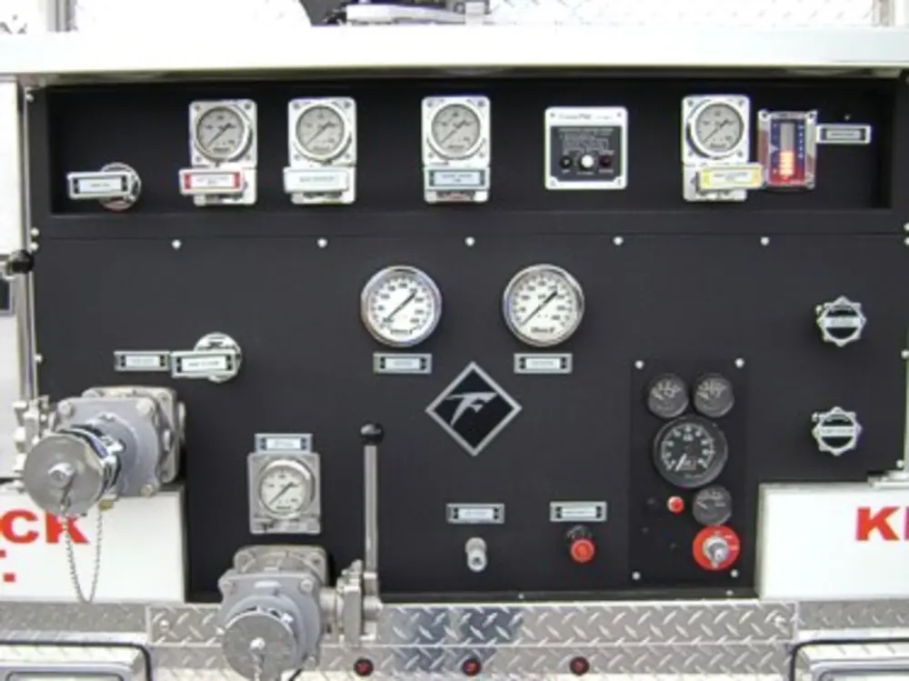 Exterior view of small fire truck showing cab, body compartments, and wheel/tire area.