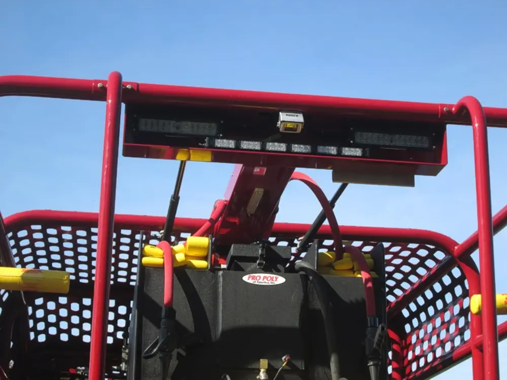 Exterior view of small fire truck showing cab, body compartments, and wheel/tire area.