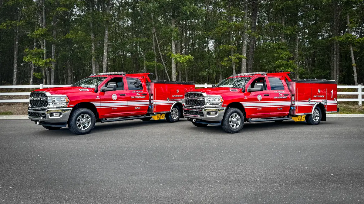 Two red LAFD utility trucks parked side by side.