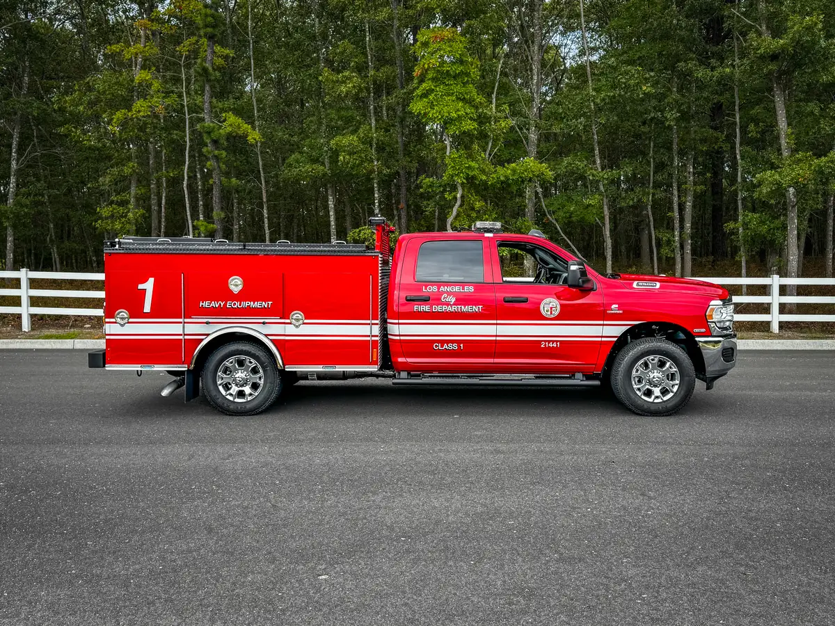 Passenger-side profile showing long utility body and striping.