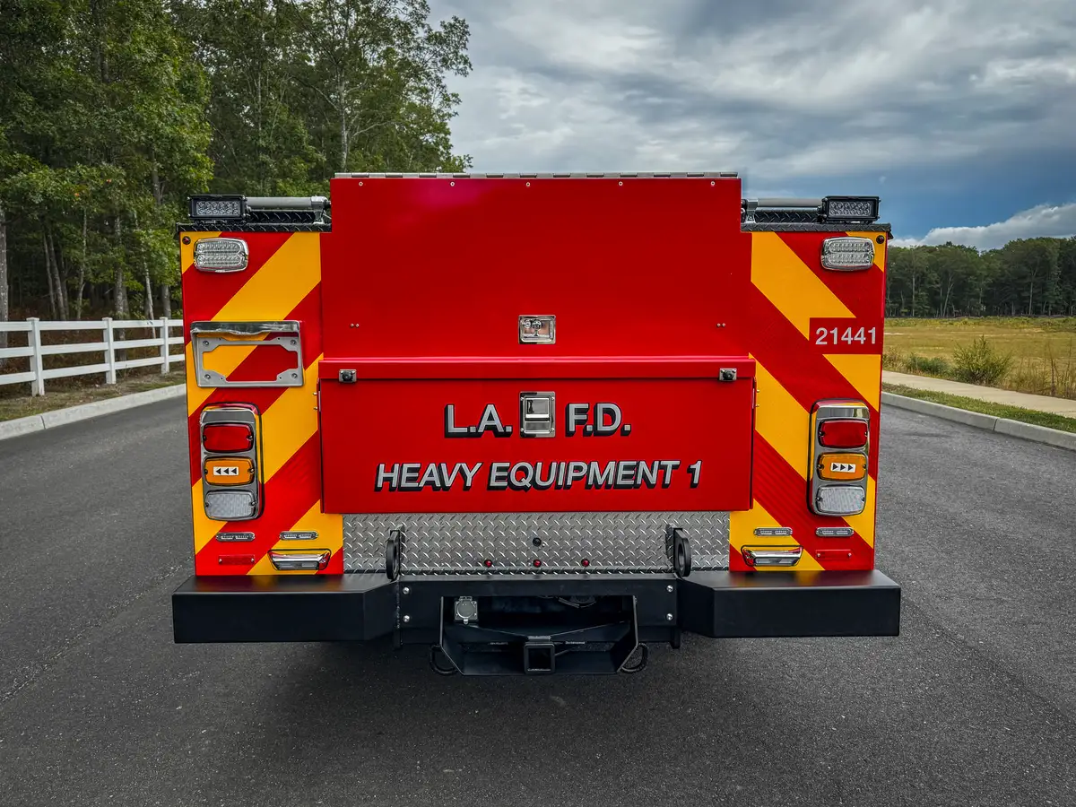 Straight rear view with red-yellow chevrons and unit markings.