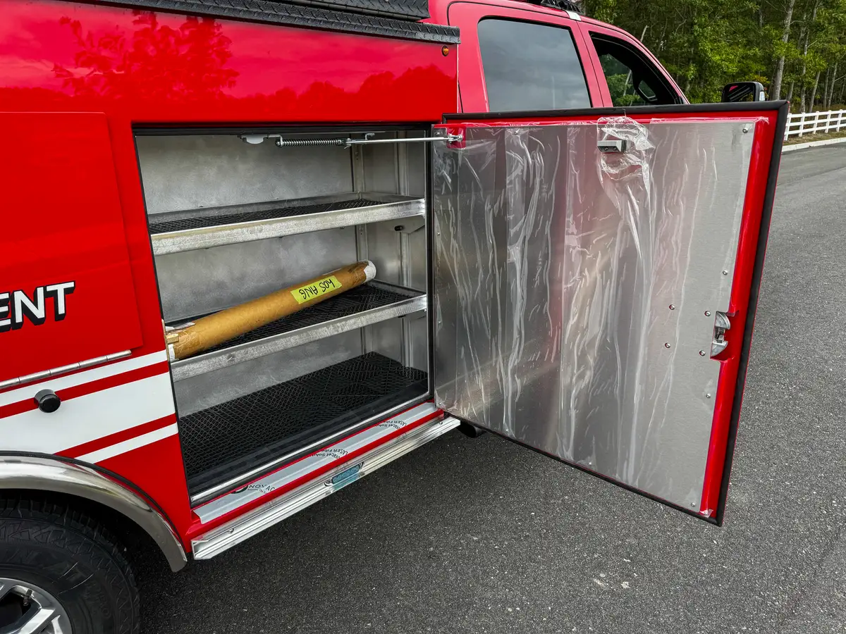 Open side compartment with long shelf and storage bay.