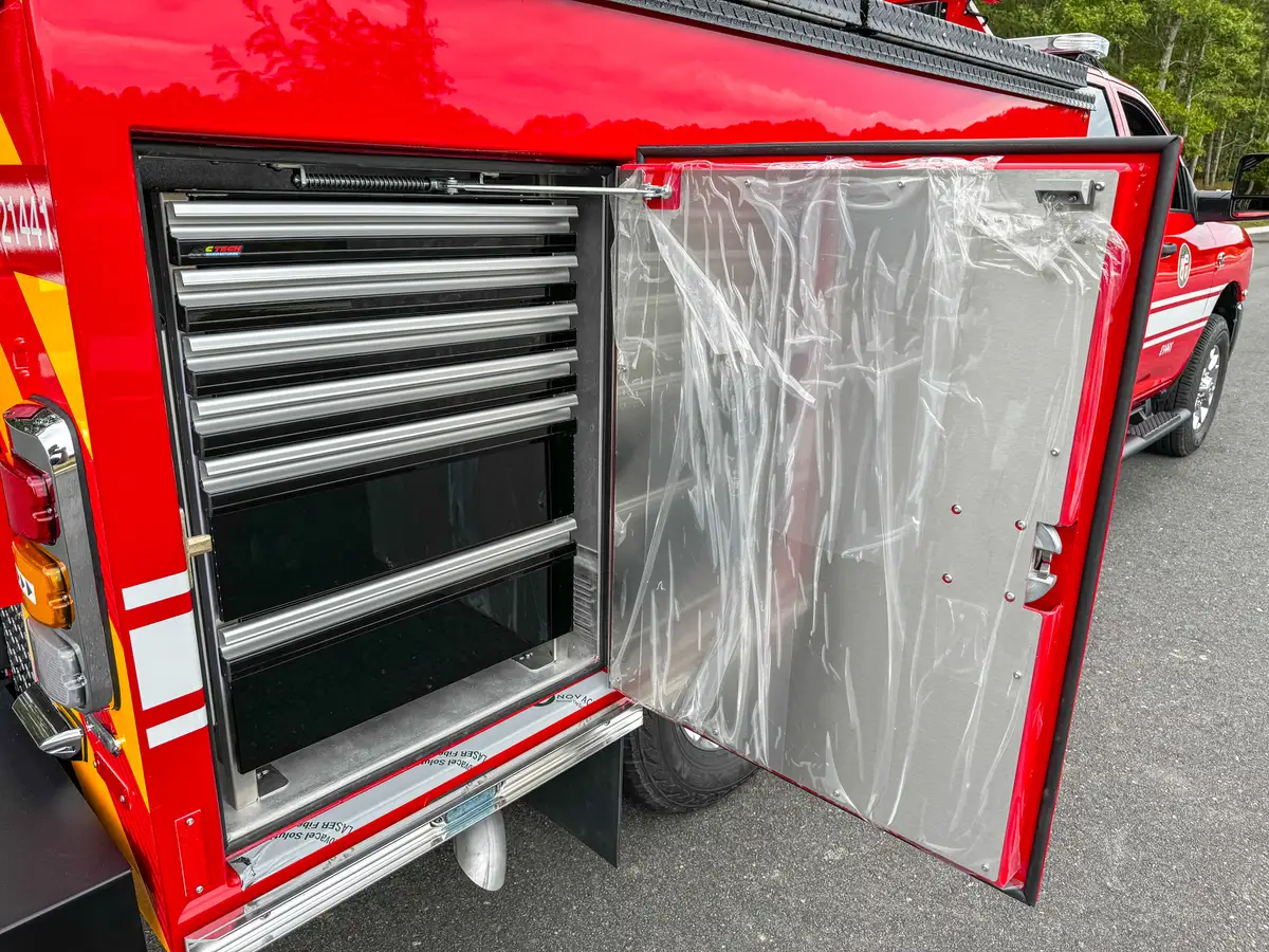 Open rear side compartment with dark mesh shelving.