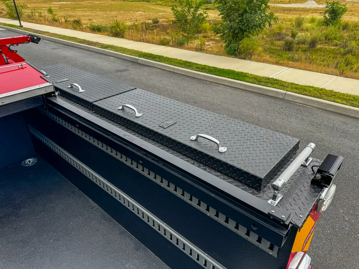 Long side rail compartment with lid panels and dividers.