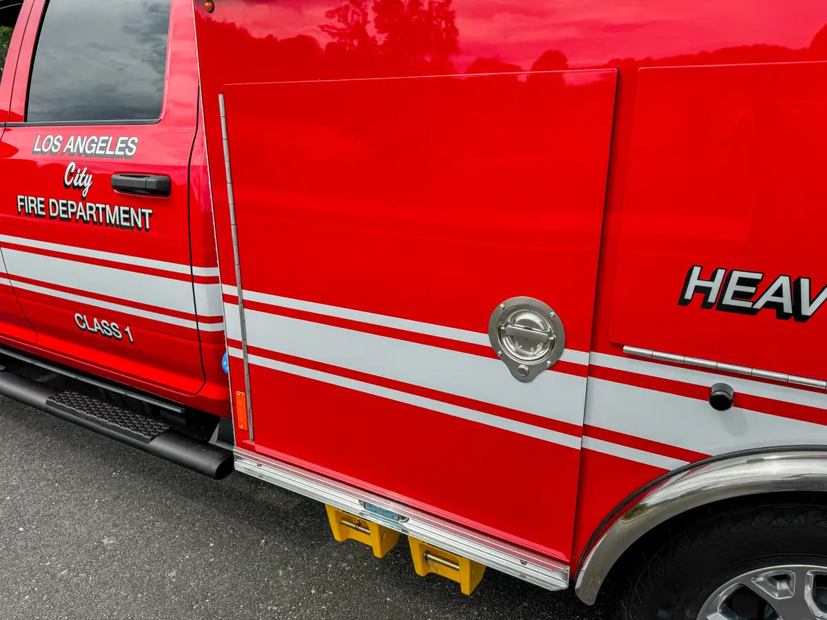 Side body panel close-up with heavy equipment lettering.