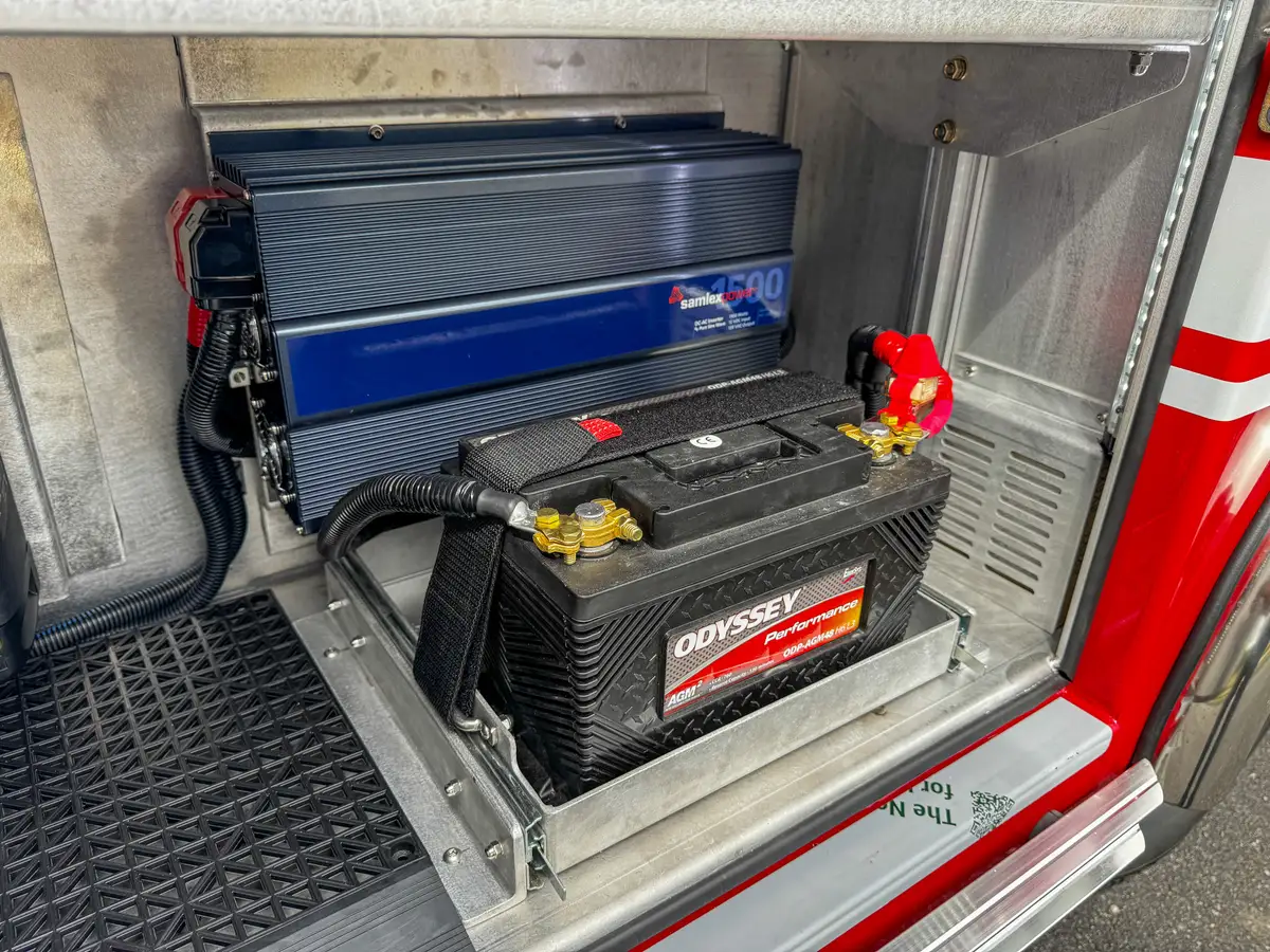 Battery compartment with charger and wiring harness.