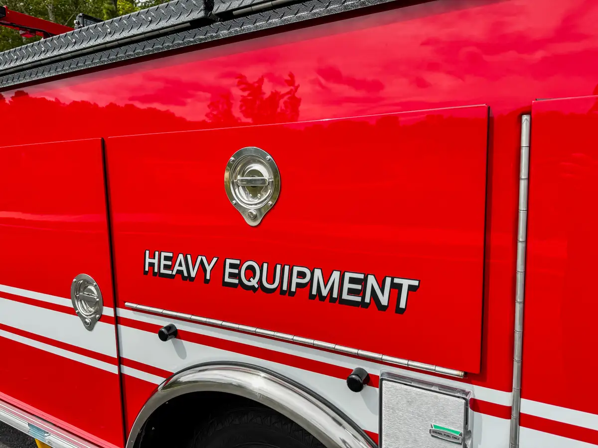 Side body panel with heavy equipment text and badge.