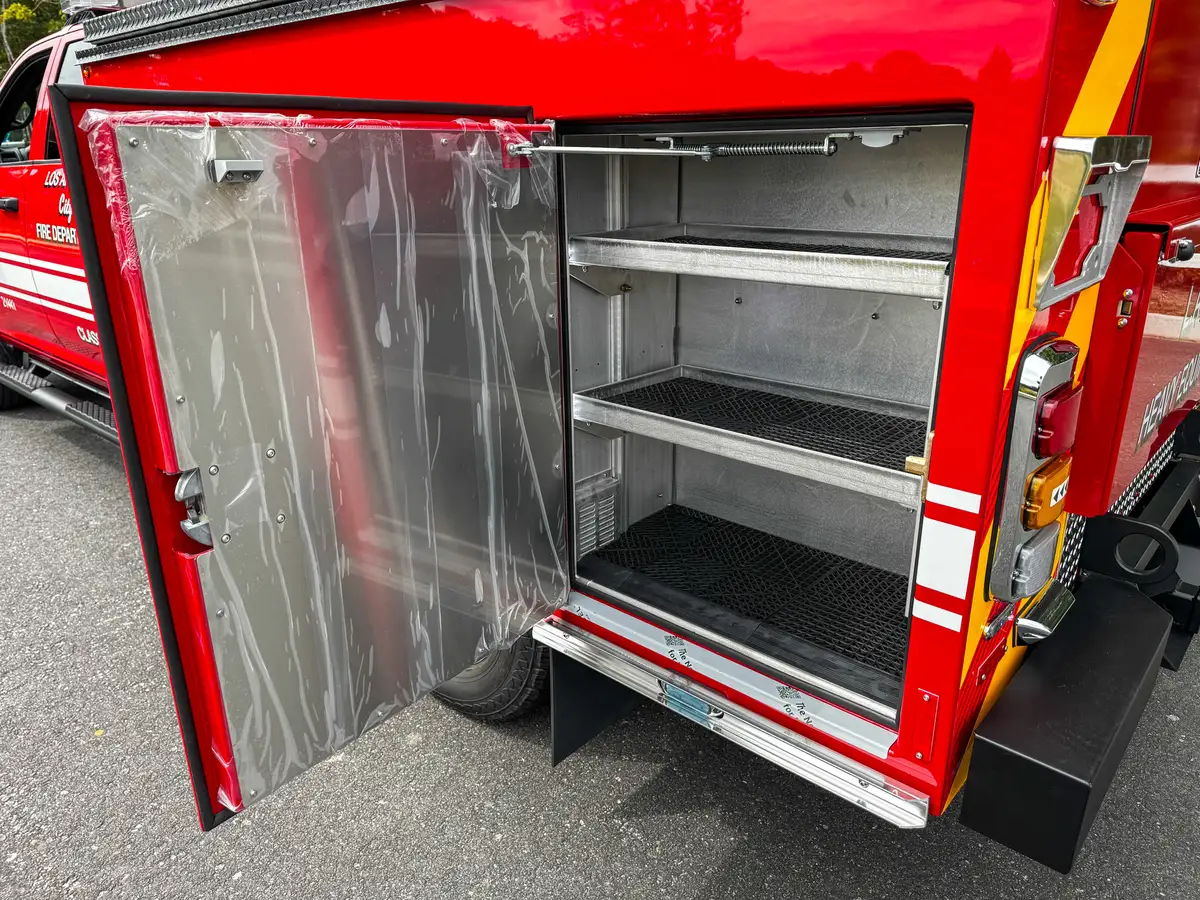 Open rear side compartment with tiered shelf storage.