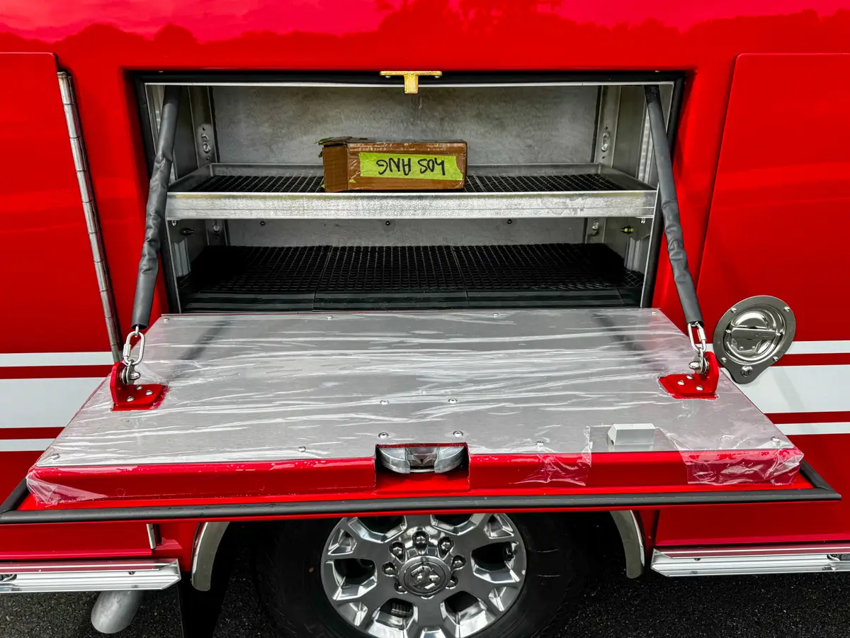 Front view into drop-down side compartment shelf bay.