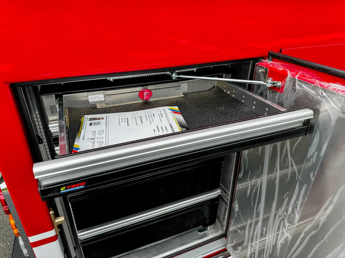 Open slide-out side drawer with shallow equipment tray.
