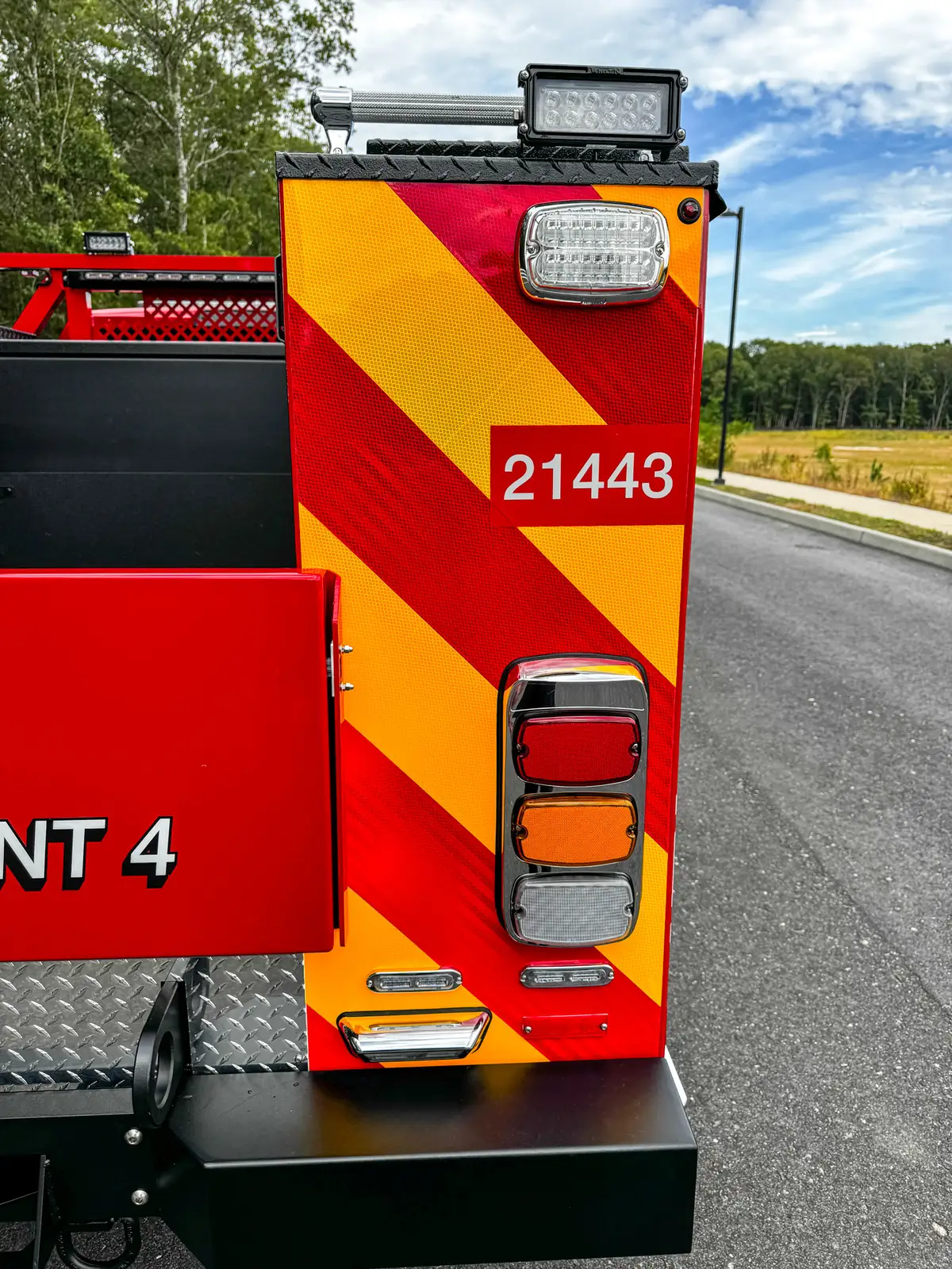 Rear corner close-up with taillight and unit number decal.