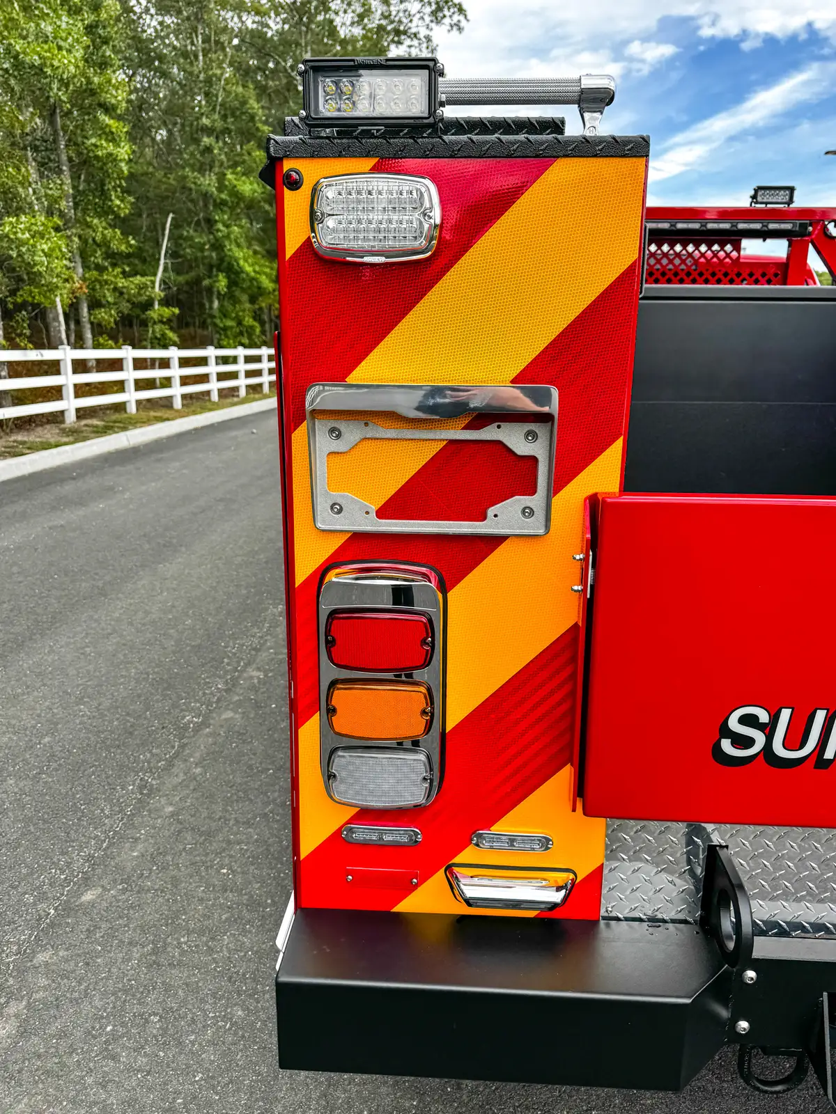 Opposite rear corner close-up with chevron and taillight.