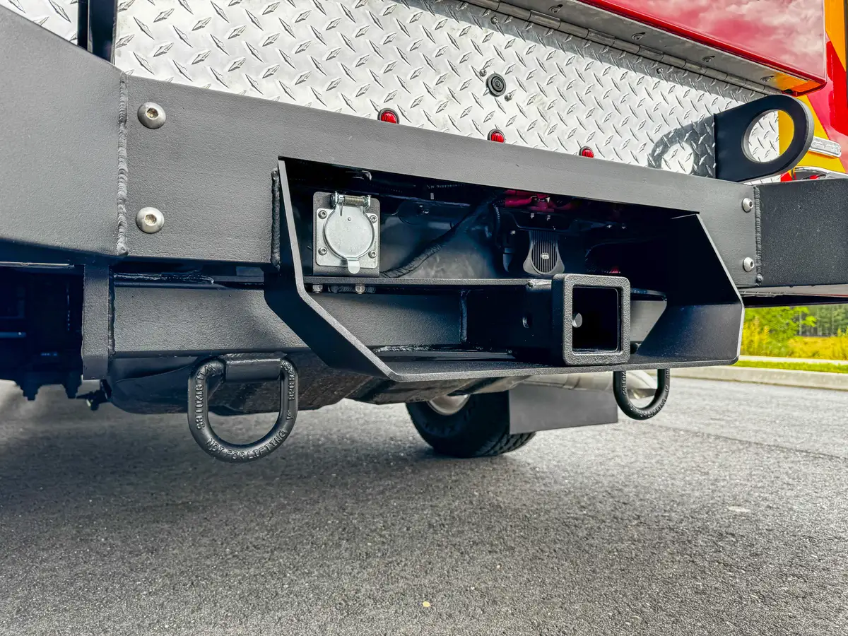 Underside rear hitch and tow point assembly close-up.