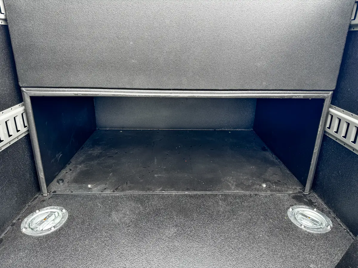 Inside right-side bed compartment with dark floor.