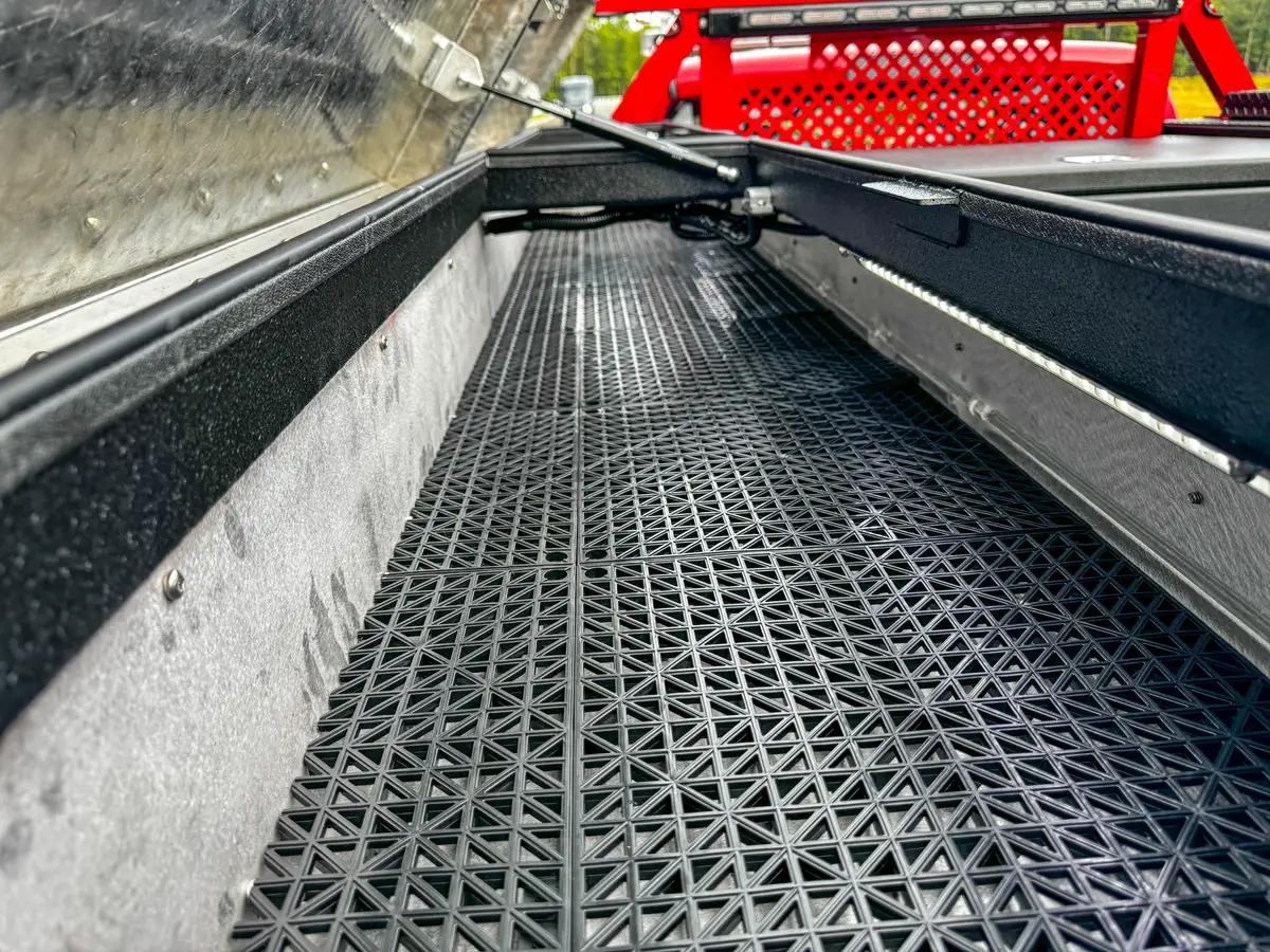 Extended bed rail storage channel with grated floor.