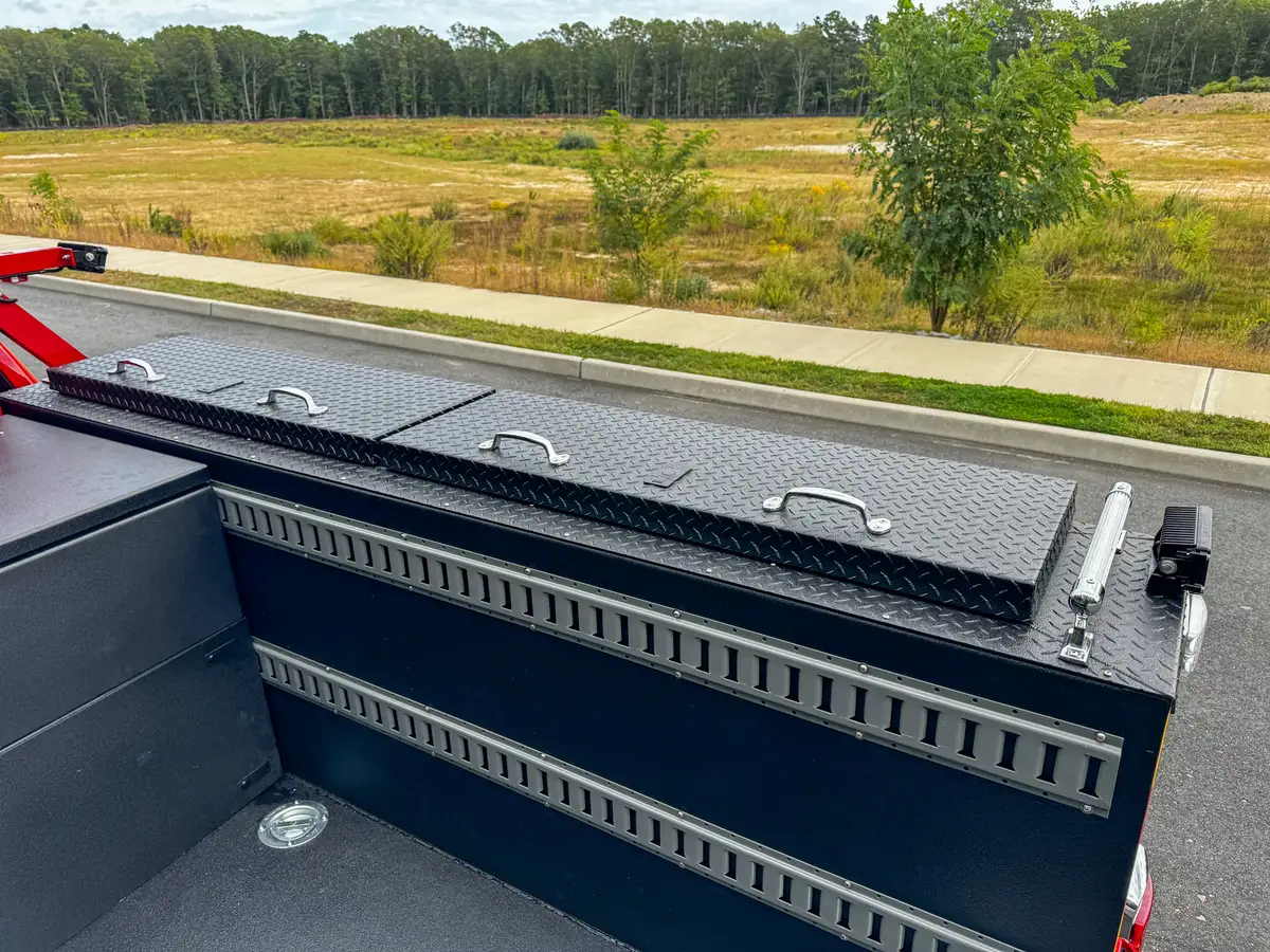 Rear corner of bed showing side rail storage opening.