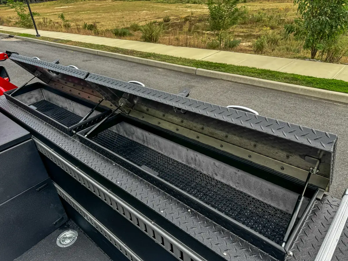 Open side rail compartment with ladder-style divider slots.