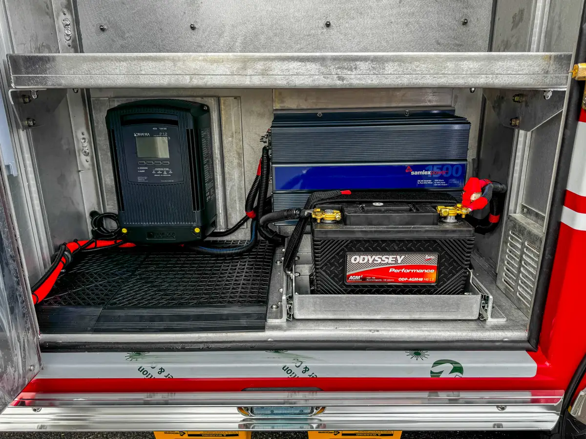 Interior compartment close-up with charger and power cables.