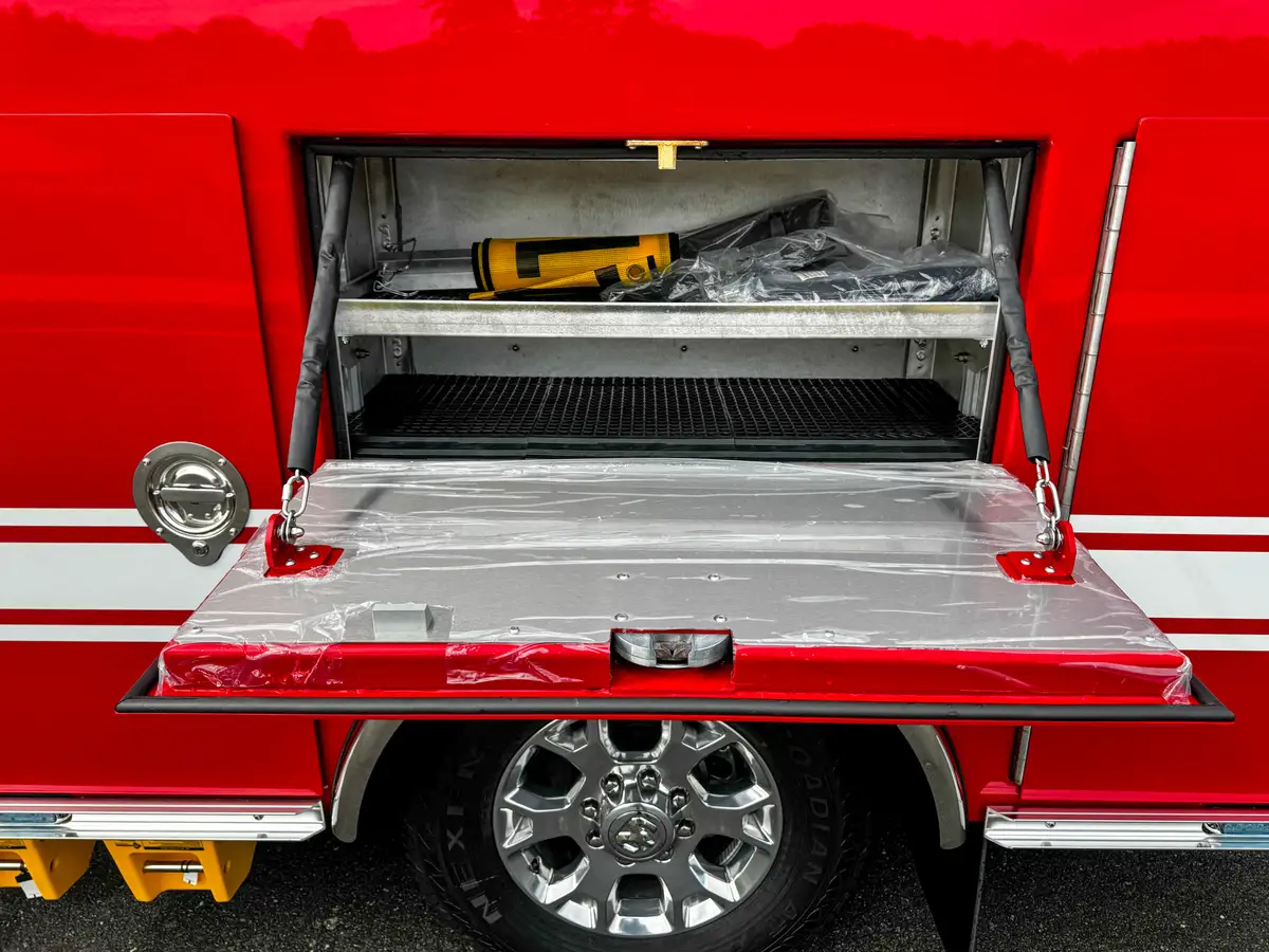Open drop-down shelf compartment with tool mounted inside.