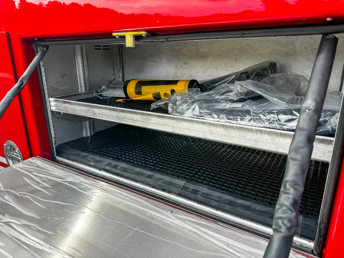 Open side drawer compartment with wrapped shelf insert.