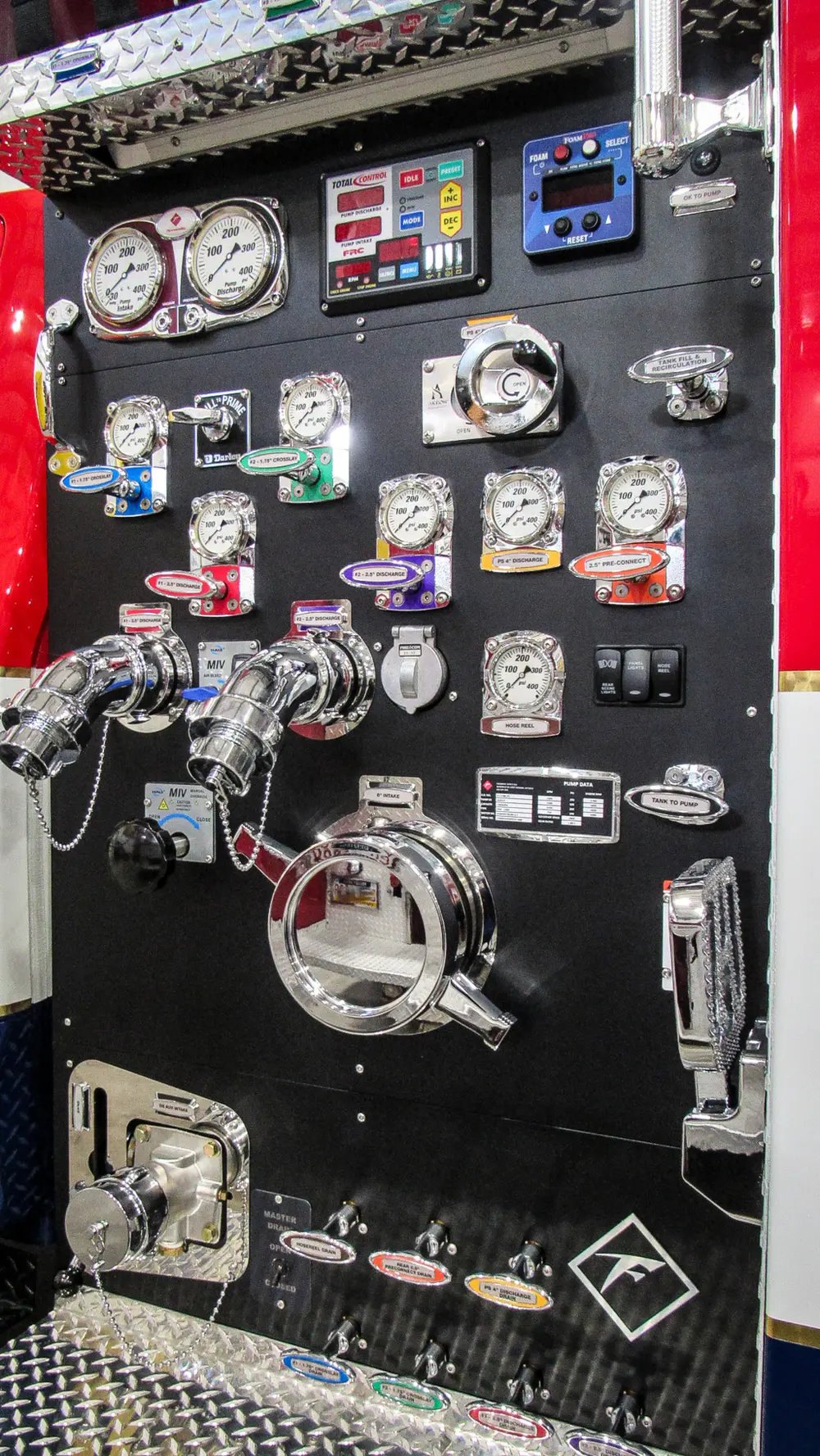 Exterior view of small fire truck showing cab, body compartments, and wheel/tire area.