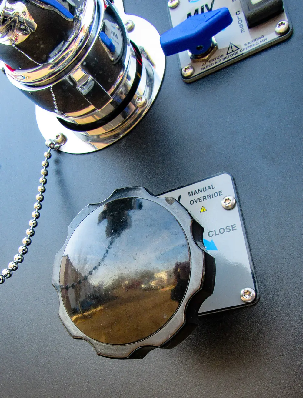 Exterior view of small fire truck showing cab, body compartments, and wheel/tire area.