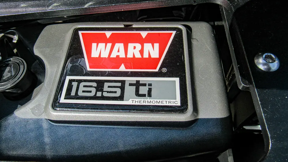 Exterior view of small fire truck showing cab, body compartments, and wheel/tire area.