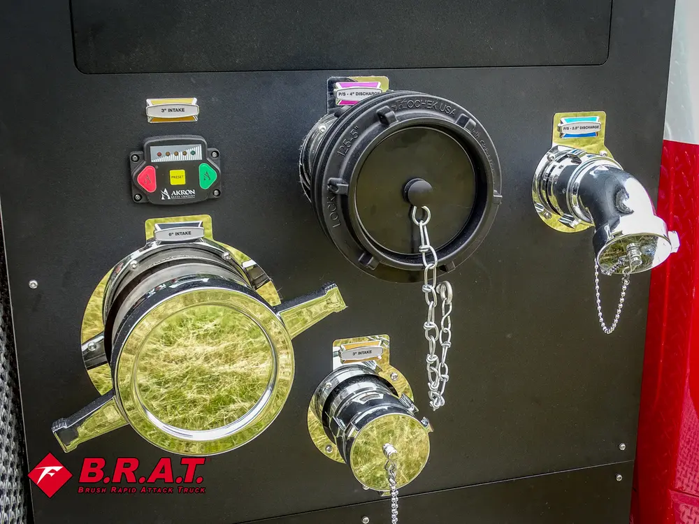 Exterior view of small fire truck showing cab, body compartments, and wheel/tire area.