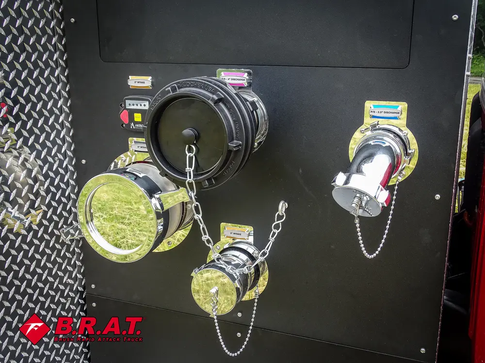 Exterior view of small fire truck showing cab, body compartments, and wheel/tire area.