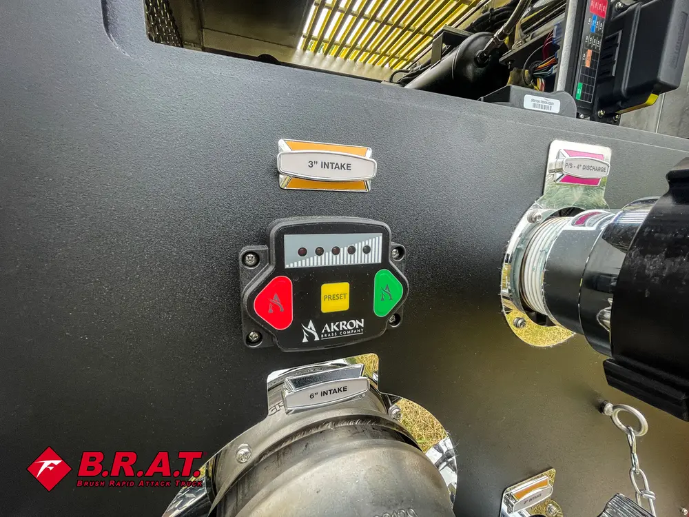 Exterior view of small fire truck showing cab, body compartments, and wheel/tire area.