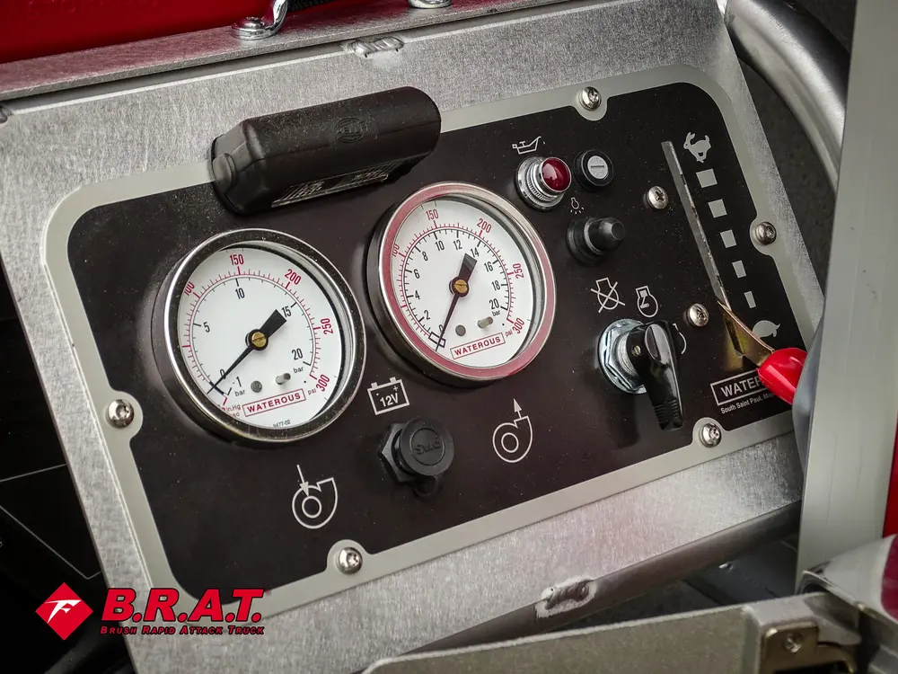 Exterior view of small fire truck showing cab, body compartments, and wheel/tire area.