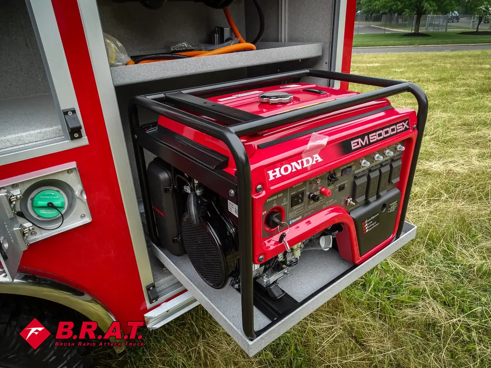 Exterior view of small fire truck showing cab, body compartments, and wheel/tire area.
