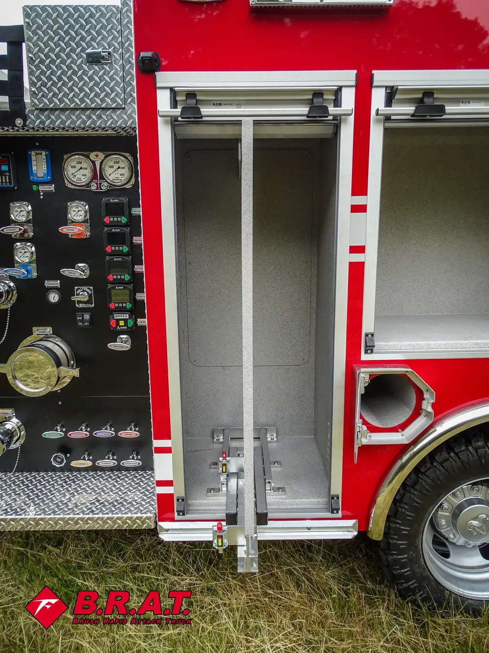 Exterior view of small fire truck showing cab, body compartments, and wheel/tire area.