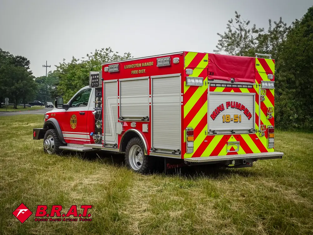 Exterior view of small fire truck showing cab, body compartments, and wheel/tire area.