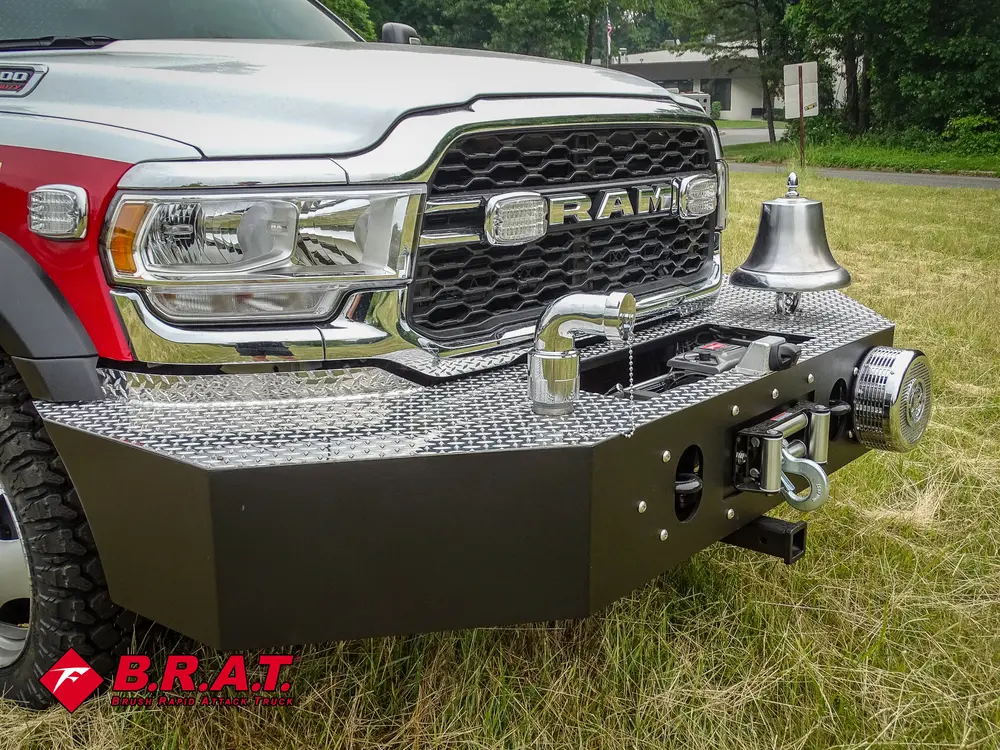 Exterior view of small fire truck showing cab, body compartments, and wheel/tire area.