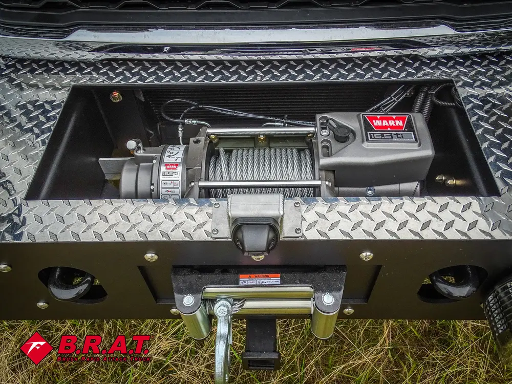 Exterior view of small fire truck showing cab, body compartments, and wheel/tire area.