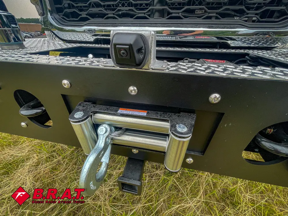 Exterior view of small fire truck showing cab, body compartments, and wheel/tire area.
