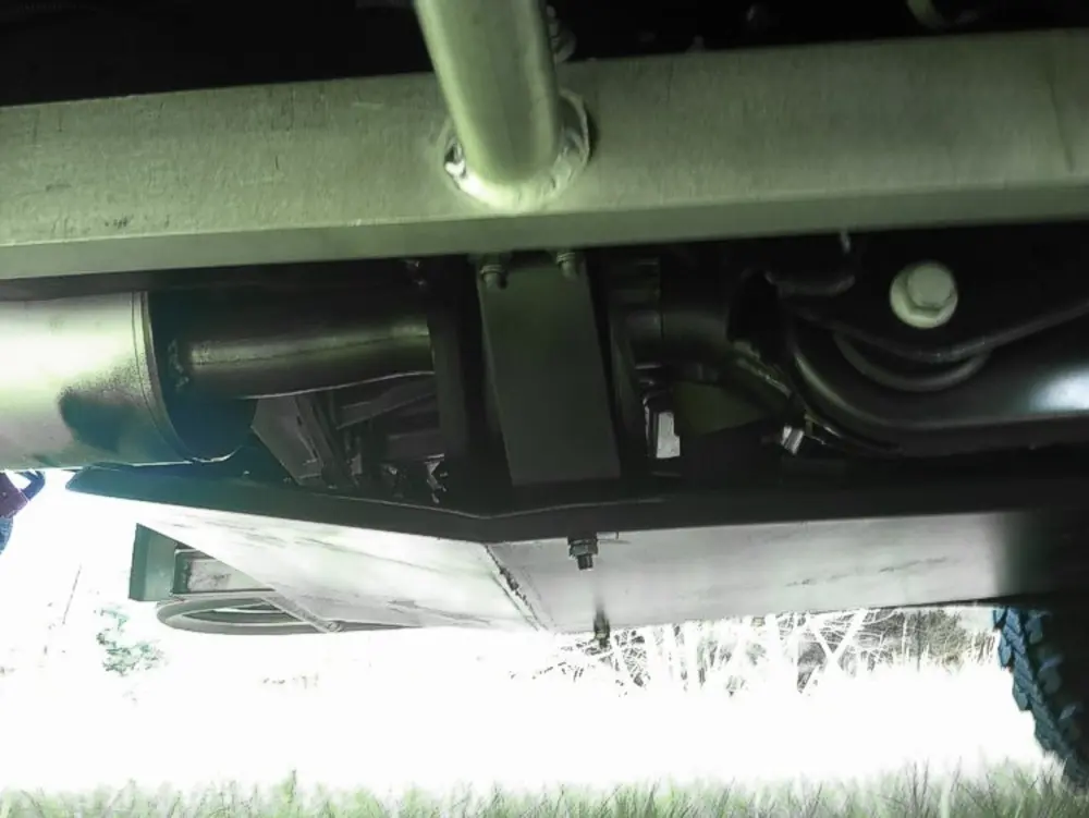 Exterior view of small fire truck showing cab, body compartments, and wheel/tire area.