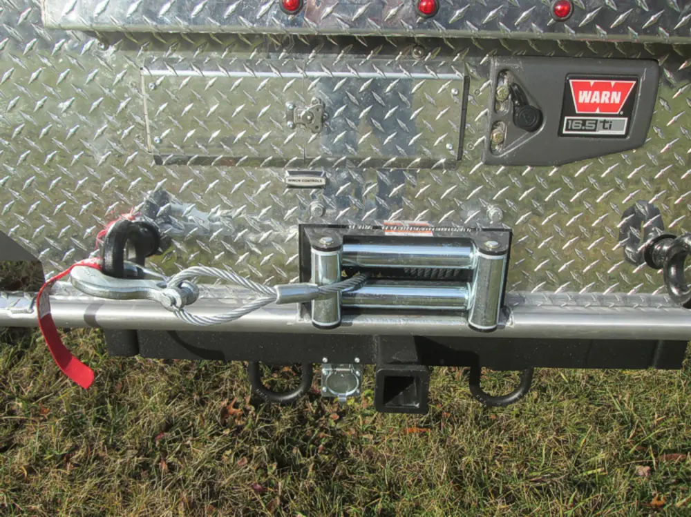Exterior view of small fire truck showing cab, body compartments, and wheel/tire area.