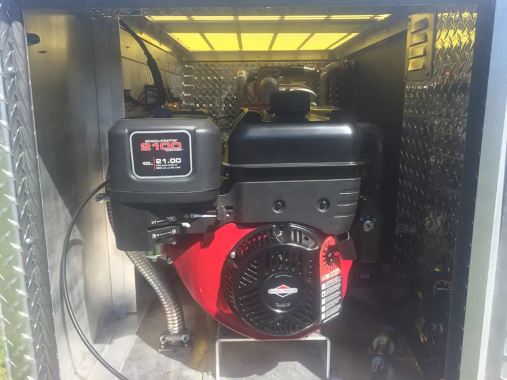 Exterior view of small fire truck showing cab, body compartments, and wheel/tire area.