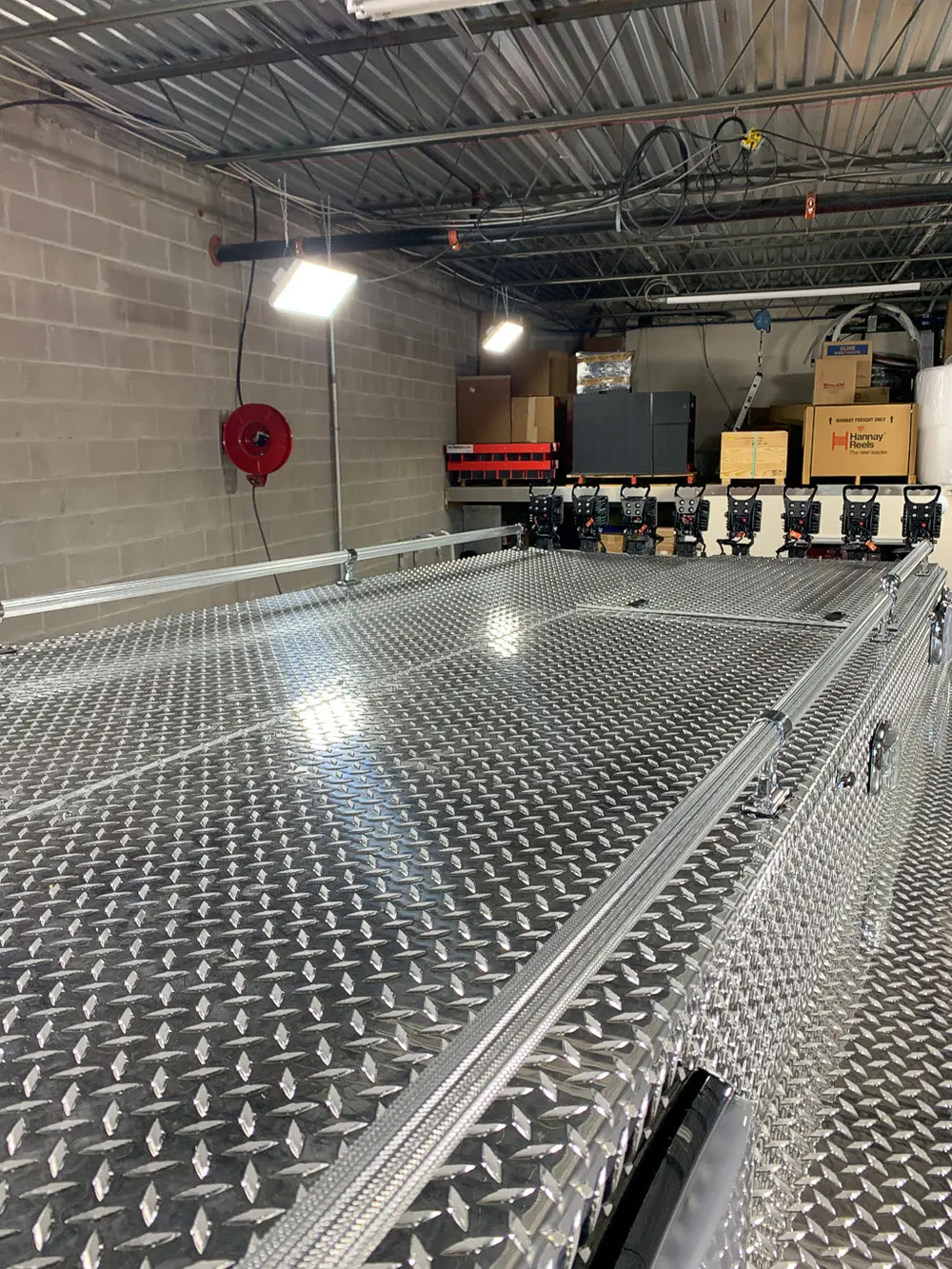 Exterior view of small fire truck showing cab, body compartments, and wheel/tire area.