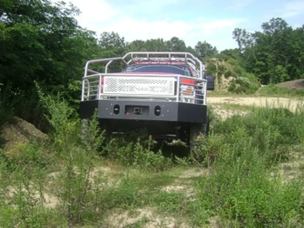 Exterior view of small fire truck showing cab, body compartments, and wheel/tire area.