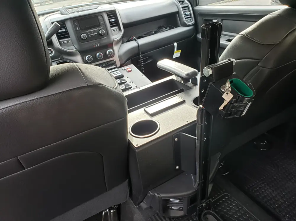 Exterior view of small fire truck showing cab, body compartments, and wheel/tire area.