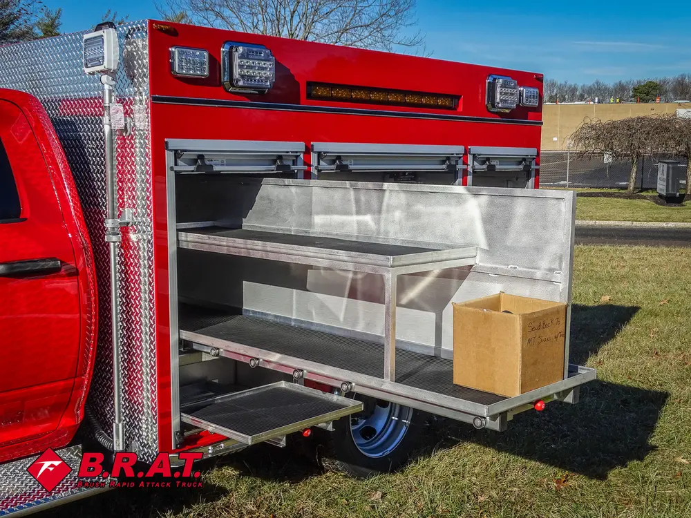 Open side compartment with long slide-out tray extended and box on shelf.